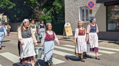 Frauen verkleidet als Waschfrauen laufen auf einer Straße in Göppingen