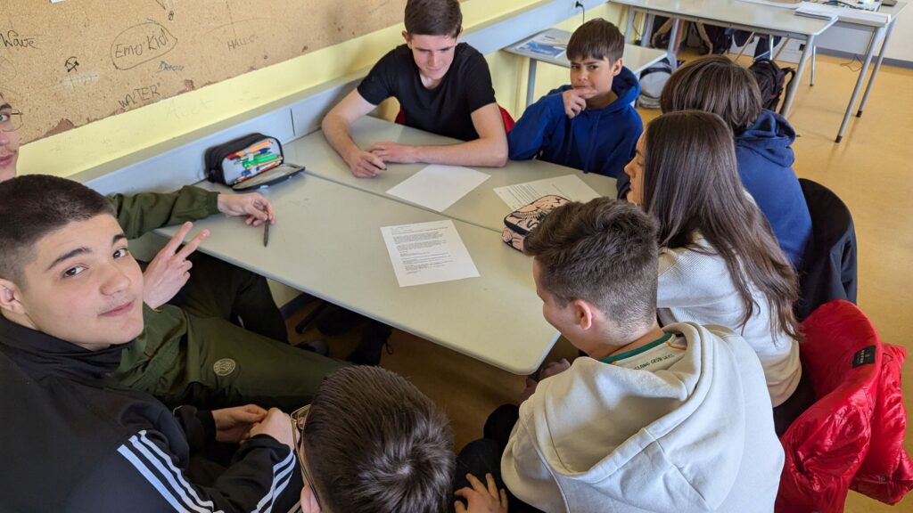 Schüler sitzen und arbeiten gemeinsam am Tisch